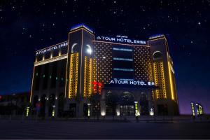 TurfanにあるAtour Hotel (Turpan Wenhua West Road)の夜はホテルがライトアップされます。