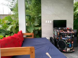 a bedroom with a bed with a tv at Larue Pocket Villa in Calatagan