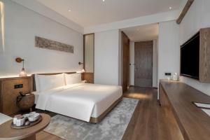 Postel nebo postele na pokoji v ubytování Sahe Hotel Shanghai World Expo
