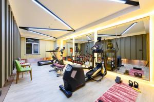 a gym with several treadmills and elliptical machines at Atour Hotel High Tech Changchun in Changchun