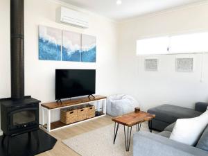 a living room with a couch and a fire place at Augusta House in Bremer Bay