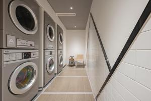 a laundry room with a row of washing machines at Atour Hotel Shanghai Jiading Juyuan Wisdom Center in Jiading