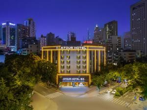 a lit up hotel in a city at night at Atour Hotel Chengdu Wenshufang in Chengdu