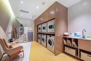 a laundry room with a washer and dryer at Atour Hotel Chengdu Wenshufang in Chengdu