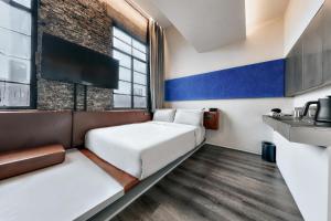 a small room with a bed and a window at Z Hotel Shanghai Bund Shamei Building in Shanghai