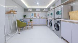 a large white laundry room with a washer and dryer at Atour Hotel (Urumqi Renmin Cinema) in Ürümqi