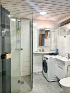 a bathroom with a washing machine and a sink at Nice and cozy big house for 8 people with sauna in Vantaa