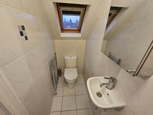 a small bathroom with a toilet and a sink at Large 4 bedrooms golders green in London