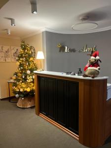 a christmas tree in a room with a teddy bear on the counter at Mon Ami Villa in Chişinău