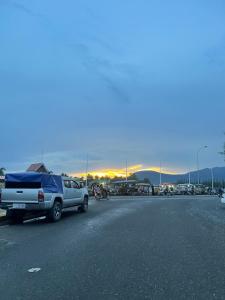 a parking lot with a bunch of cars and a truck at Kim Chua Guest House in Kampot