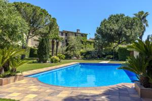 a swimming pool in a yard with trees and a building at Catalunya Casas Unique sanctuary with extra large pool! in Santa Oliva
