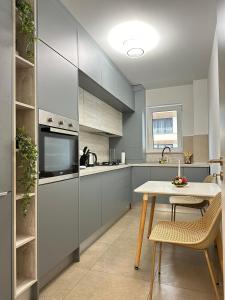 a kitchen with a table and a counter top at Coresi Mall Area Studios & Apartments by GLAM in Braşov