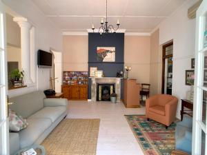 a living room with a couch and a fireplace at Dale Court Guest House in Cape Town