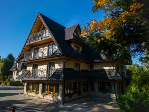 a large house with a gambrel roof at Willa Maria 4 in Zakopane