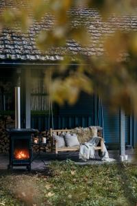 a couch sitting on a porch next to a fireplace at Bregenzerwald Ferienhaus in Egg