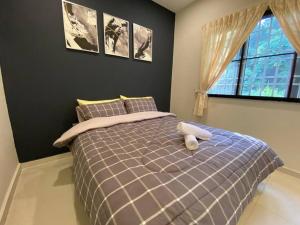 Llit o llits en una habitació de Kaezen Houz Ipoh