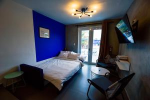 a blue bedroom with a bed and a blue wall at The Surfing Turtle in Luquillo