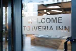 a sign that says we welcome to neccain on a window at Iveria Inn Hotel in Tbilisi City