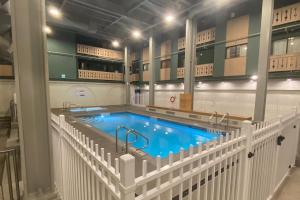 a swimming pool with two faucets in a building at Snow Ghost Inn, Unit #311 in Big White