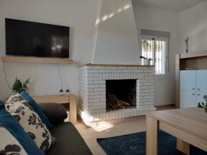 a living room with a fireplace and a tv at Chalet Antonio in Benalmádena