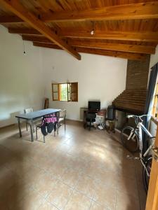 a dining room with a table and a bike in a room at Casa Frank in Bermejo