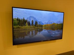 a flat screen tv hanging on a wall at Adobe Suites in Salta
