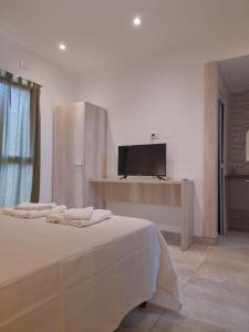 a bedroom with a bed with a tv on the wall at Yunka Alquiler temporario, Salta, Vaqueros in Vaqueros