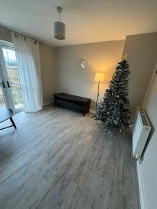 a living room with a christmas tree on the floor at ane in Peterborough