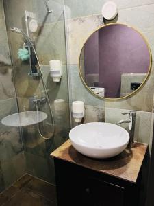 a bathroom with a sink and a mirror at Venice Loft with balcony downtown in Kraków