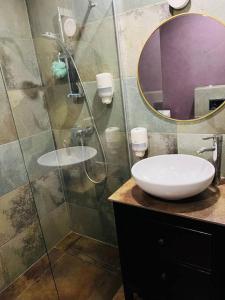 a bathroom with a shower with a sink and a mirror at Venice Loft with balcony downtown in Kraków