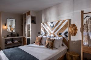 a bedroom with a large bed with a wooden headboard at Indigo Inn Casa Adults Only in Hersonissos +47 photos