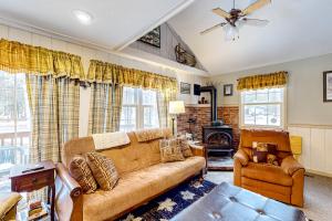 a living room with a couch and a chair at Poplar Stream Chalet in Carrabassett