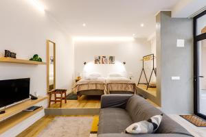 ein Wohnzimmer mit einem Bett und einem Sofa in der Unterkunft Ladomar Avenida in Horta