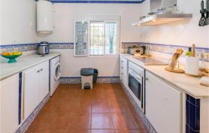 a kitchen with white cabinets and a tile floor at Beautiful Home In Carmona With Kitchen in Carmona