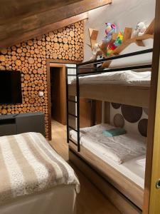 a room with three bunk beds and a television at Vila Relax in Donovaly