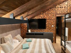 a bedroom with a bed with a flat screen tv at Vila Relax in Donovaly +22 photos