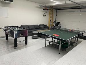 a room with two ping pong tables and a couch at Vila Relax in Donovaly
