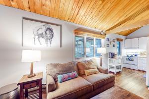 a living room with a couch and a table at Wooded Dreams in Whitefish