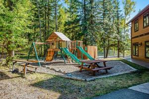 a playground with a bench and a swing at Wooded Dreams in Whitefish