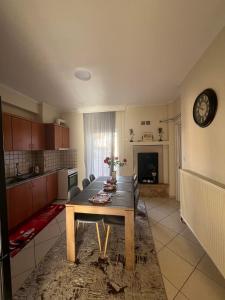 a living room with a table and a kitchen at Bakopoulos resort Ένα Όμορφο Διαμέρισμα στα Τρίκαλα in Tríkala +14 photos