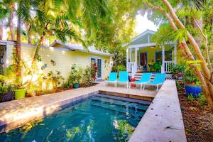 a house with a swimming pool in front of a house at Bahama House in Key West