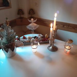 a table with candles and a christmas tree on it at Mys Chalet in Jaun