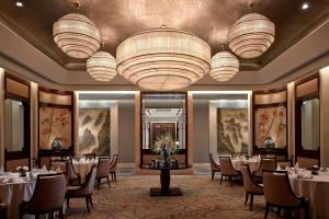 a banquet room with tables and chairs and chandeliers at Shangri-La Nanchang丨Adjacent to Pavilion Prince Teng Prime river view in Nanchang