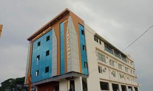 a building with blue windows on the side of it at RC Comforts in Chikmagalūr