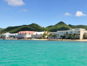 a group of buildings on a beach next to the water at Studio pirate of the Caribbean 2 sea view in Marigot