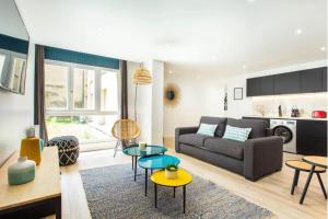 a living room with a couch and a table at Résidence Villette - Buttes Chaumont Botzaris in Paris