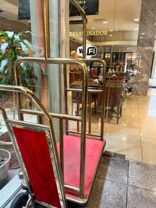 a chair in front of a store window at Hotel Everest in Cordoba