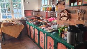 a kitchen with a counter with food on it at Nova Pousada Chamonix in Teresópolis