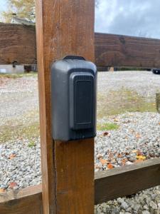 a black soap dispenser on a wooden fence at Clara Cottage in Eyam