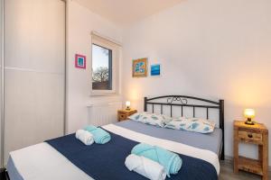 a bedroom with two beds and a window at Apartments Villa Padrone with pool - perfect for families! in Garica